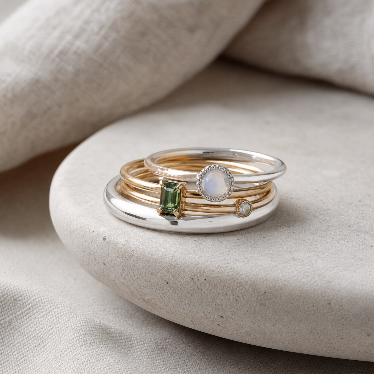 Stacked silver and gold plated rings with gemstones